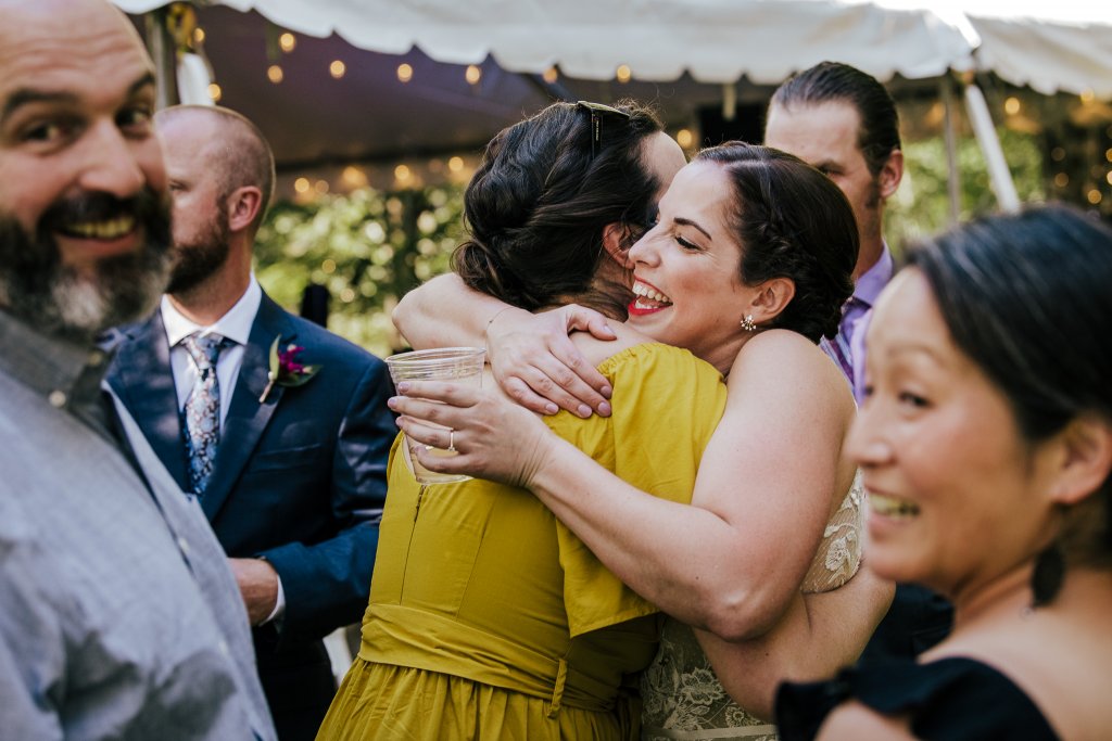bride hugs guest at a hudson valley wedding
