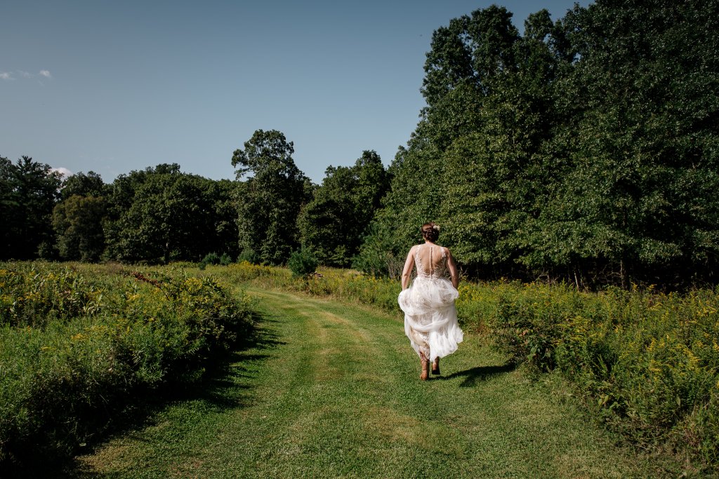 bride in a catskill field on her wedding day
