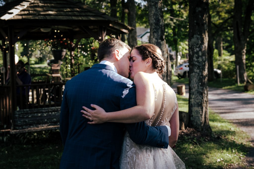 bride and groom sneak a kiss at a Shinglekill Falls B & B wedding