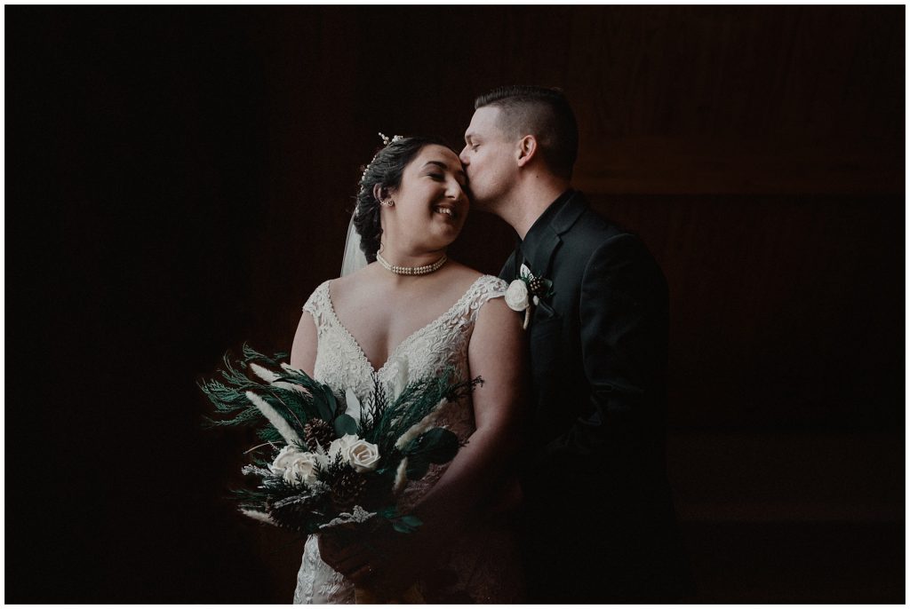 dark and moody catskill wedding photo of a bride and groom