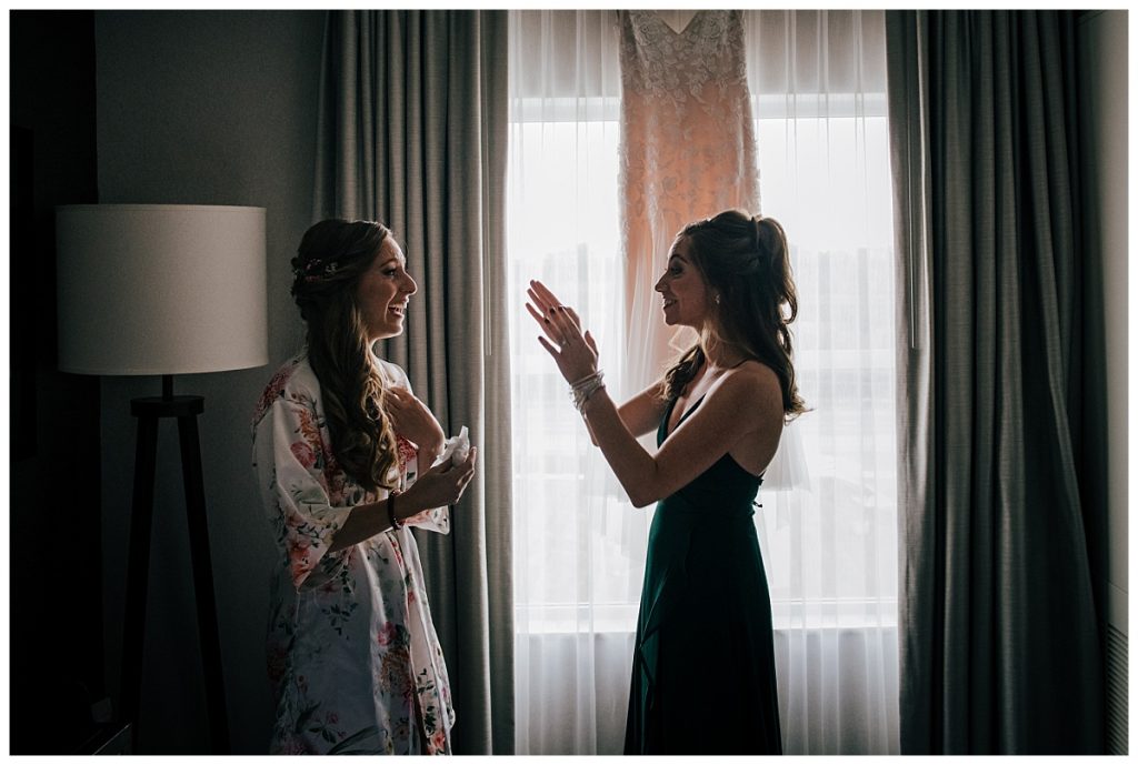 A Saratoga Springs SPAC Wedding 5 bride and maid of honor getting ready in gorgeous light