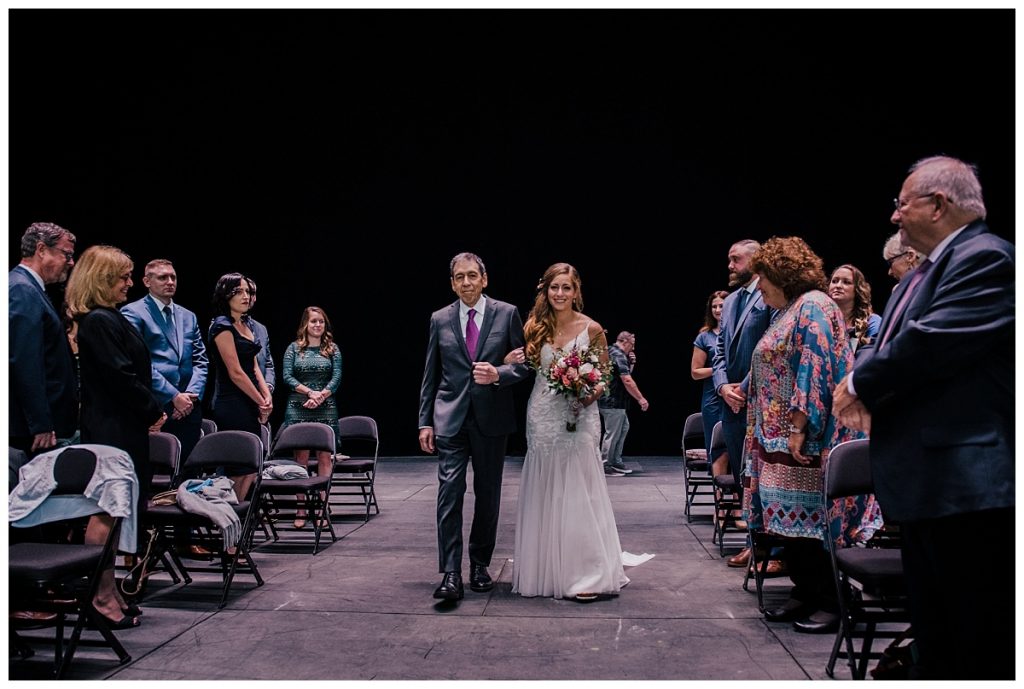 A Saratoga Springs SPAC Wedding 23 bride walking down the aisle with her dad at a spac ceremony in saratoga springs ny